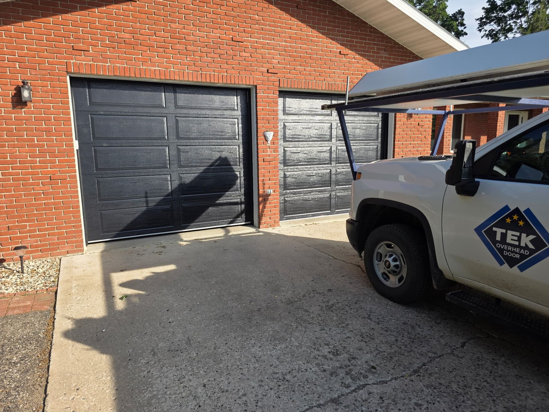Dual Black AP138 Garage Door Installation on a Raised Ranch image